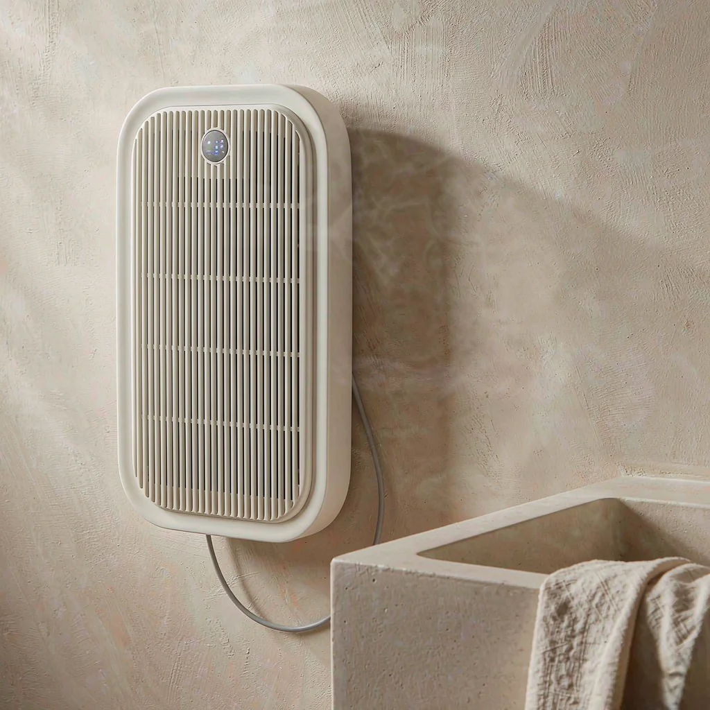 Slim white wall-mounted electric bathroom heater on a warm off-white bathroom wall